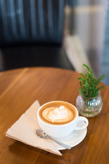 Hot art Latte Coffee in a cup on wooden table