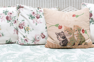 Cushions and pillows on rattan sofa