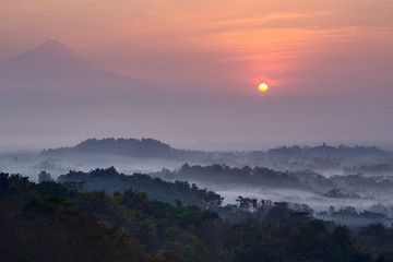 Sunrise at Setumbu hill with the view of Borobudur and  Merapi