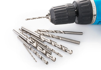 Fototapeta premium Drill and set of drill bits on white