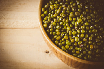 red  beans on wood background - soft focus with vintage film fil