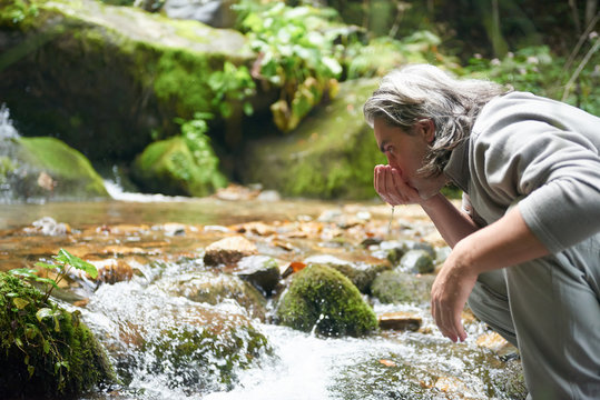 Man Drinking Fresh Water From Spring