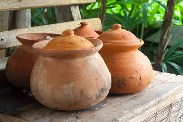 Clay pots or porttery on a shelf  outside kitchen room