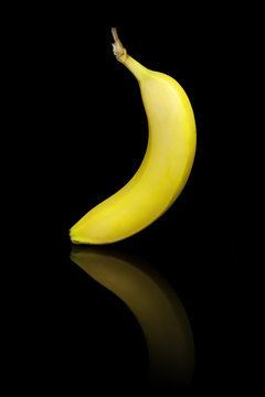 Banana on a black reflective background