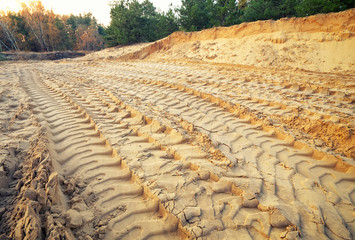 Tire tracks on the sand. Trace of wheels on the sand