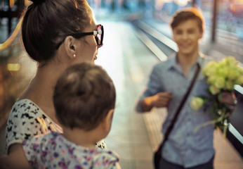 Happy family on a rail station