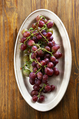 red grapes on old plate