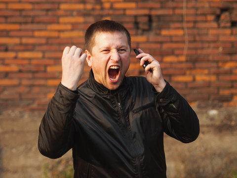 Anger - man with a cell phone yelling