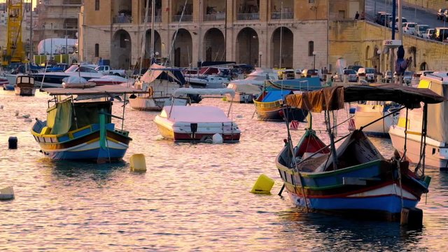 View on Malta bay between Kalkara and Birgu with yahts at evening time
