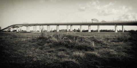 The Gateway Bridge (Sir Leo Hielscher Bridges) at sunset in Brisbane, Queensland, Australia. Abstract black and white image.