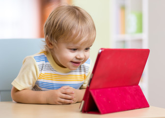 Fototapeta na wymiar Cute kid toddler boy with tablet pc