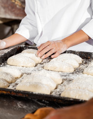 Midsection Of Woman With Bread Dough In Baking Tray