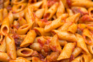 Mezze Penne with ragout, closeup, Italian food 