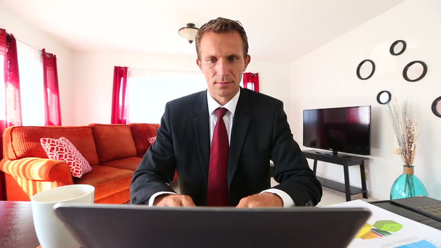 Caucasian Businessman Working on laptop computer at home