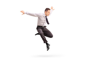 Young businessman jumping in the air