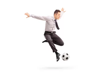 Foto op Canvas Young businessman kicking a football © Ljupco Smokovski