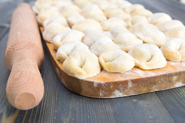 Handmade meat dumplings on the kitchen board