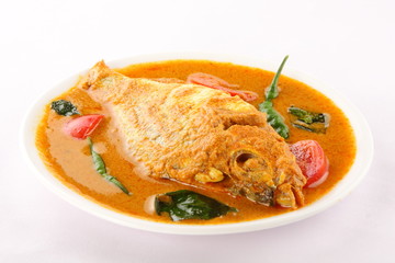 Turmeric,red chili,ginger ,coconut ,tomato,Traditional fish curry from Asian cuisine.