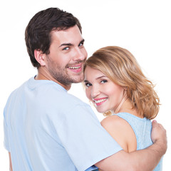 Back view of young couple in embrace.