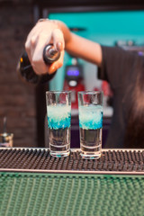 Girl bartender prepares cocktails clouds
