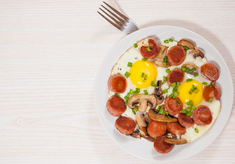 fried eggs with mushrooms and sausage