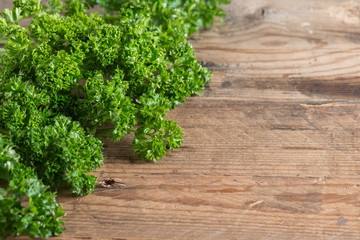 Fresh parsley on wooden background.
