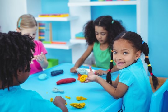 Smiling Kids Using Modelling Clay