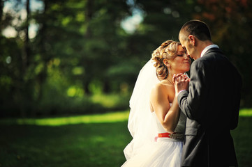 Young and gorgeus wedding couple on autumn forest