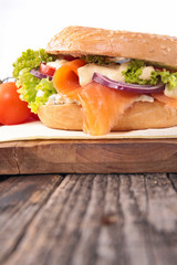 salmon and vegetable on bagel sandwich