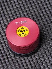 Specialist container with warning sticker and engraving containing radioactive isotope...
