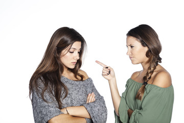 Closeup portrait of woman pointing at her friend because she did something wrong, isolated on white background