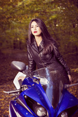 Fototapeta na wymiar Beautiful Biker girl on a motorcycle