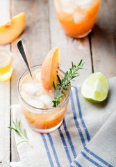 Peach and rosemary fizz cocktail on a wooden background. Cocktail.