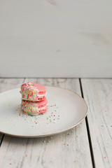 Chocolate Dipped Pink Macaroons with Berries Buttercream and Sprinkles