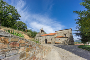 Obraz premium Pobladura de aliste romanic church wide angle view over blue sky