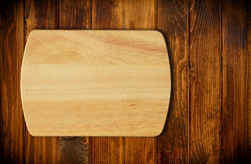 Empty cutting board on a wooden table.Top view
