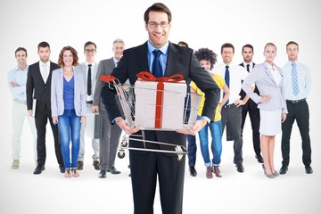 Obraz premium Composite image of businessman holding something with his hands
