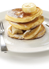 fluffy ricotta pancakes with banana isolated on white background