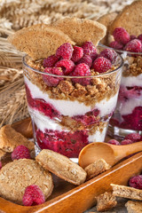 healthy meal with fresh raspberries, cream and biscuits of rye