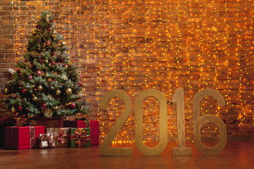Letters '2016' and decorated Christmas tree on brick wall background - Powered by Adobe