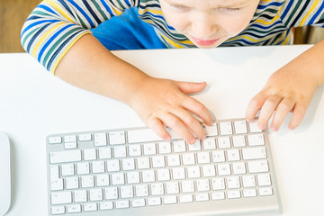Fototapeta na wymiar young boy is writing something on a keypad