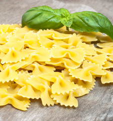 Fine farfalle noodles on wooden board