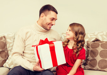 smiling father and daughter looking at each other