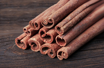 Cinnamon, a spice on a wooden base, close-up.