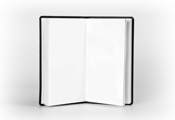 Opened notebook with blank pages on white background.