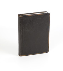 Naklejka premium Black notebook in leather cover on white background.