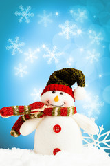 Christmas snowman, snow and snowflakes on a blue background.