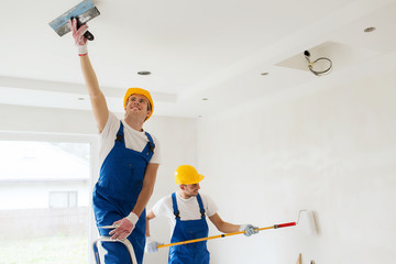 group of builders with tools indoors