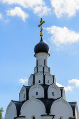 Cross on the dome of  the church against the blue sky