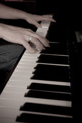 Close-up of hand playing the piano